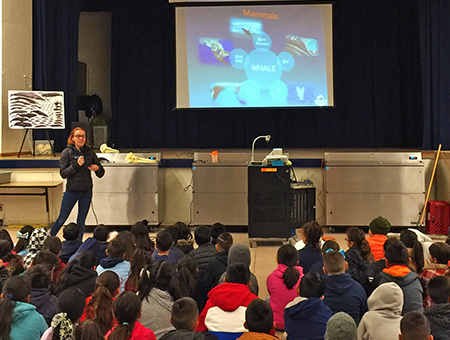 One of the Marine Education Specialists giving a presentation to a group of students.